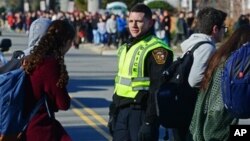 Tenafly High School students return to their building after being evacuated to the middle school in Tenafly, N.J., Tuesday, Jan. 19, 2016. Authorities say bomb threats were made against schools in New Jersey, but none of the threats are considered valid. (Tariq Zehawi/The Record of Bergen County via AP) 
