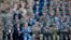 U.S. Army Pacific commander Gen. Robert Brown and Gen. Liu Xiaowu, the commander for Southern Theater Command Army of Chinese Liberation Army, applaud with their soldiers at a group photo session after conducting the U.S.-China Disaster Management Exchange (DME) drill at a PLA&#39;s training base in Kunming in southwest China&#39;s Yunnan province.