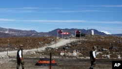 FILE - Indian army soldiers walk along the line of control at the India- China border in Bumla in the northeastern Indian state of Arunachal Pradesh, Oct. 21, 2012. 