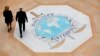 FILE - People walk past the Interpol logo at the headquarters of the international police agency in Lyon, France, Nov.8, 2018. 