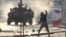 FILE - A protester throws a bottle at riot police during anti-government clashes in the Bahrainian village of Sitra, Feb. 14, 2016. A new Amnesty International report says rights violations persist in the kingdom. 