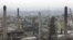 FILE -Chimneys from the Engen oil company are seen on the outskirts of Durban, South Africa.