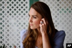 FILE — Britain's Kate, Duchess of Cambridge, attends a reception for parents of users of a Centre for Early Childhood, at Kensington Palace in London, Friday, June 18, 2021