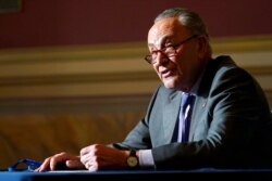 Senate Minority Leader Chuck Schumer of New York speaks to reporters on Capitol Hill in Washington, Dec. 30, 2020.