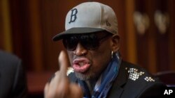 FILE - Dennis Rodman speaks with fellow U.S. basketball players during a team meeting at a Pyongyang, North Korea hotel.