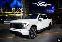 A Ford F-150 electric truck is displayed at the Rouge Electric Vehicle Center, Tuesday, April 26, 2022, in Dearborn, Mich. (AP Photo/Carlos Osorio)