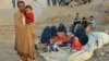 An Afghan family waits for help from the government and aid organizations in Takhar, Afghanistan, Oct. 11, 2016, after fleeing their homes in neighboring Kunduz, which has been the scene of fighting between militants and government troops.