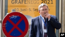 Russia's Governor to the International Atomic Energy Agency (IAEA), Mikhail Ulyanov, smokes a cigarette near the 'Grand Hotel Vienna' where where closed-door nuclear talks take place in Vienna, Austria, June 12, 2021. 