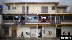 People walk past a building where Haitian migrants rent apartments in Tijuana, Mexico, Feb. 26, 2017. 