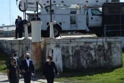 FILE - President Joe Biden (C) and Mayor of New Orleans LaToya Cantrell (R) take a tour of the Carrollton water treatment plant, in New Orleans, Louisiana, May 6, 2021.