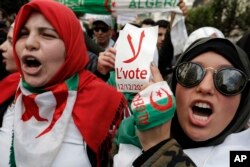 FILE—An Algerian student holds a poster reading "No to the vote on Dec.12" during a protest in Algiers, January 10, 2019.