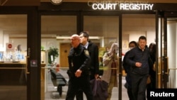 People are escorted out of the court registry by a B.C. sheriff after the B.C. Supreme Court bail hearing of Huawei CFO Meng Wanzhou, who was released on a $10 million bail in Vancouver, British Columbia, Canada, Dec. 11, 2018.