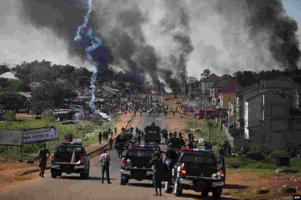 Nigerian police fire teargas at people during clashes between youths in Apo, Abuja, following the ongoing demonstrations against the brutality of the Special Anti-Robbery Squad (SARS).