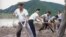 In this undated image from video distributed on Sept. 12, 2016, by North Korean broadcaster KRT, North Korean workers build levees along a river bank.