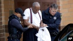 Bill Cosby is escorted out of the Montgomery County Correctional Facility, Sept. 25, 2018, in Eagleville, Pennsylvania, following his sentencing to three-to-10-year prison sentence for sexual assault.