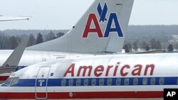 American Airlines planes sit at a gate at Washington's Ronald Reagan National Airport. American Airlines and its parent company are filing for bankruptcy protection as they try to cut costs and unload massive debt built up by years of high fuel prices and