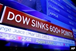 A television screen displays the Dow Jones industrial average story, on the floor of the New York Stock Exchange, Feb. 2, 2018.