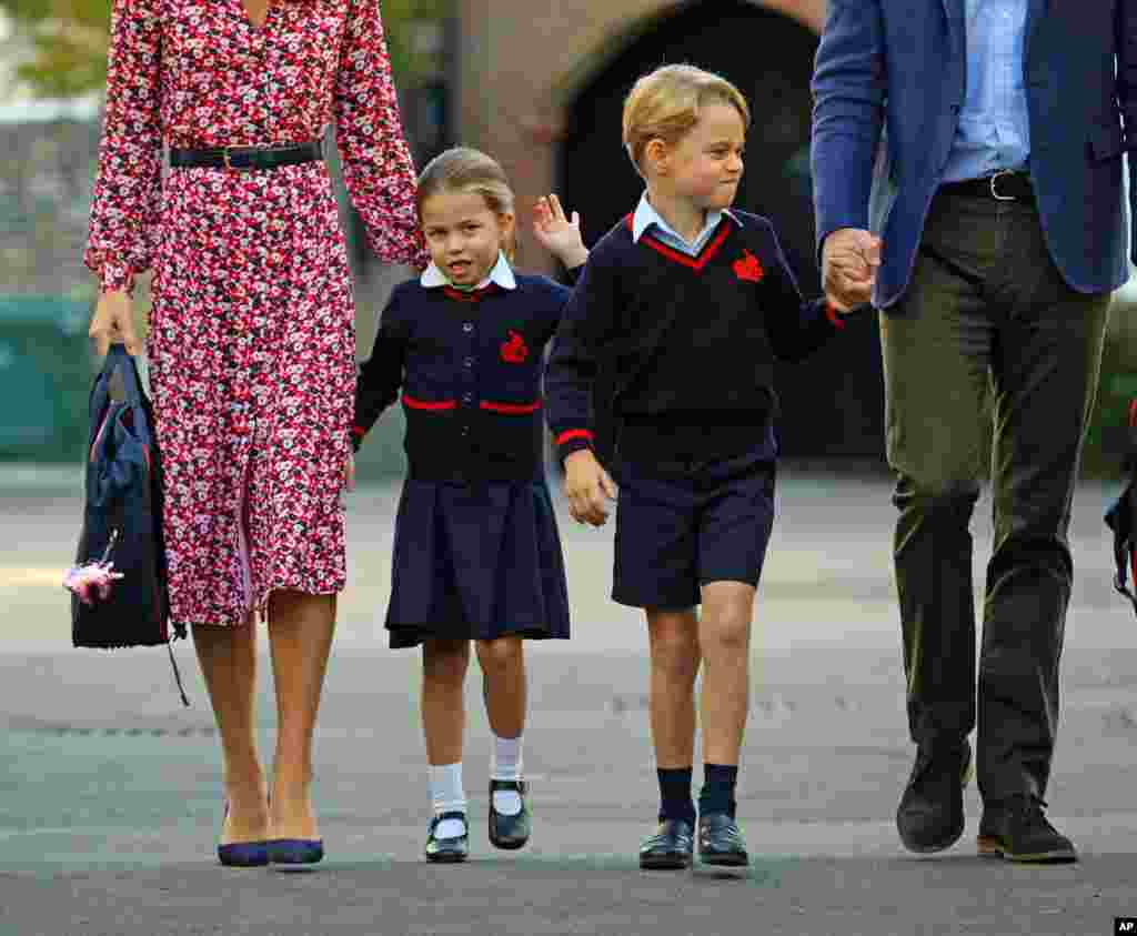 Britain&#39;s Princess Charlotte, left, with her brother Prince George and their parents, Prince William and Kate, Duchess of Cambridge, arrives for her first day of school at Thomas&#39;s Battersea in London.