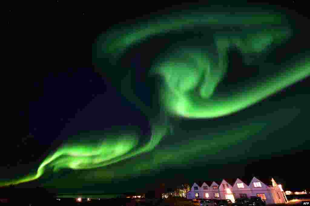 The aurora borealis, also known as northern lights, illuminates the sky along the Ring Road in southeastern Iceland, between Jokullsarlon glacier lagoon and Hofn, Oct. 7, 2018.