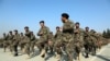 FILE - In this Jan. 18, 2021, photo, new Afghan National Army troops march during their graduation ceremony after a three-month training program at the Afghan Military Academy in Kabul, Afghanistan.