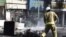 In this photo taken by an individual not employed by the Associated Press and obtained by the AP outside Iran, an Iranian fire fighter extinguishes a burned motorcycle in a street in central Tehran, near Tehran's old main bazaar, October 3, 2012. 
