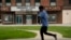 A person jogs past a movie theater temporarily closed due to the coronavirus outbreak April 6, 2020, in St. Louis.