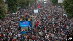 Pro-democracy protesters march during a street 