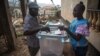 A voter casts his ballot at a polling station in Freetown, Sierra Leone, March 7, 2018. (Photo: Jason Patinkin / VOA) 