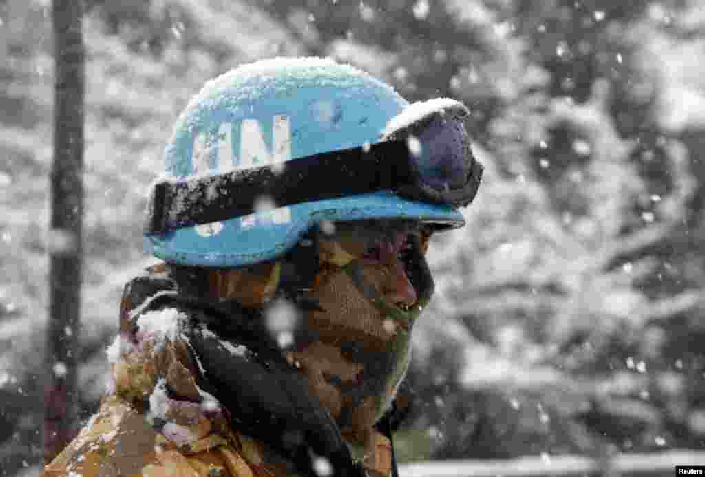 An Indonesian soldier from the United Nations Interim Forces in Lebanon is seen during a snow fall in the southern Lebanese village of Adaisseh, Dec. 13, 2013. 