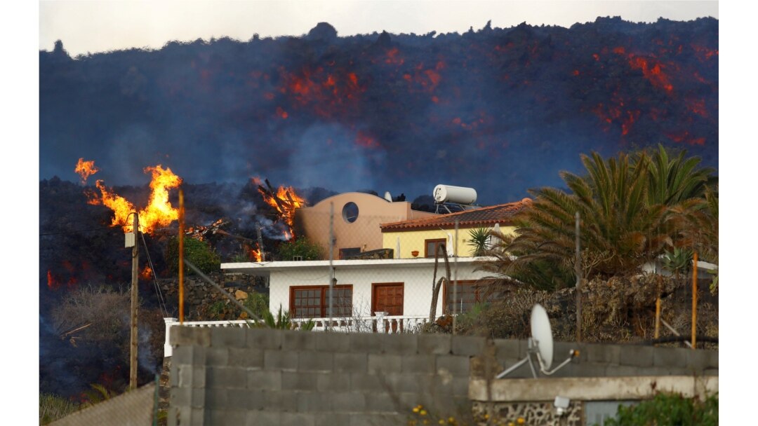 FILE - A house burns due to lava following the eruption of Cumbre Vieja Volcano, on the Canary Island of La Palma, Spain, Oct. 27, 2021.