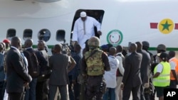 Gambian President Adama Barrow, disembarks a plane as he arrives at Banjul airport in Gambia, Thursday Jan. 26, 2017, after flying in from Dakar, Senegal.