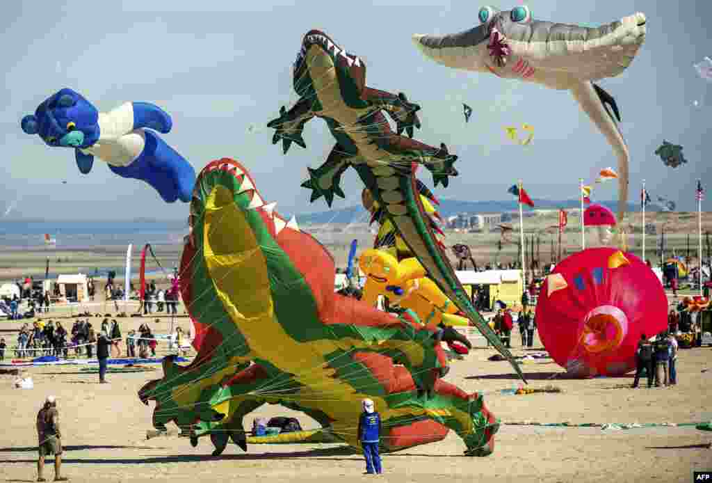 People fly kites during the 30th International Kite Festival in Berck-sur-Mer in northern France.