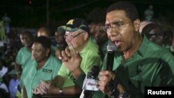 FILE - Andrew Holness (R), leader of the opposition Jamaican Labour Party, speaks to supporters at the party headquarters in Kingston, Jamaica, Feb. 25, 2016. 