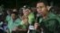 Andrew Holness (R), leader of the opposition Jamaican Labour Party, speaks to supporters at the party headquarters after they won the general election in Kingston, Jamaica, Feb. 25, 2016. 