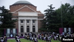 Law professor Xu Zhangrun was fired for “moral corruption” and publishing articles that undermines the Communist Party of China, according to the dismissal notice from Tsinghua University. A graduation ceremony at Tsinghua from June is pictured above.