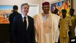 FILE - U.S. Secretary of State Antony Blinken, left, poses for a photo with Nigerien President Mohamed Bazoum during their meeting at the presidential palace in Niamey, Niger, March 16, 2023.