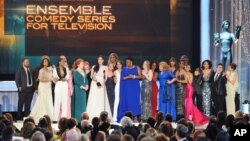 Laura Prepon, center, and the cast and crew of “Orange is the New Black” accept the award for outstanding ensemble in a comedy series at the 22nd annual Screen Actors Guild Awards at the Shrine Auditorium & Expo Hall, Jan. 30, 2016, in Los Angeles.