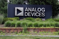 A sign points toward the headquarters of Analog Devices, Inc., July 13, 2020, in Norwood, Massachusetts.