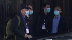 FILE - Members of the World Health Organization team including Peter Daszak, left, Ken Maeda, right, and Vladimir Dedkov, second right, prepare to leave for field visits from their hotel in Wuhan in central China's Hubei province.