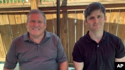 This photo from June 26, 2020 shows Buck Newsome, left, a Baby Boomer, and his son, Chris Newsome, of the Millennial generation, as they pose for a photo while having lunch together in Newtown, Ohio.