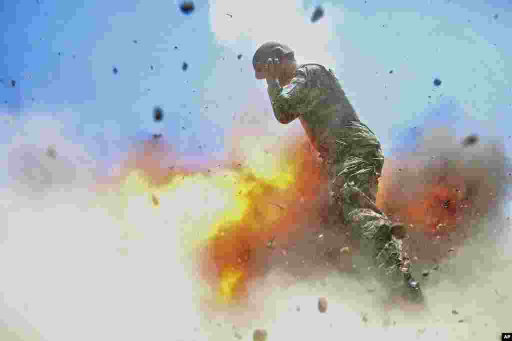 This image released by the U.S. Army shows an Afghan soldier engulfed in flame as a mortar tube explodes during an Afghan National Army live-fire training exercise in Laghman Province. U.S Army combat camera photographer Spc. Hilda Clayton took this photo on July 2, 2013. The accident killed Clayton and four Afghan National Army soldiers.