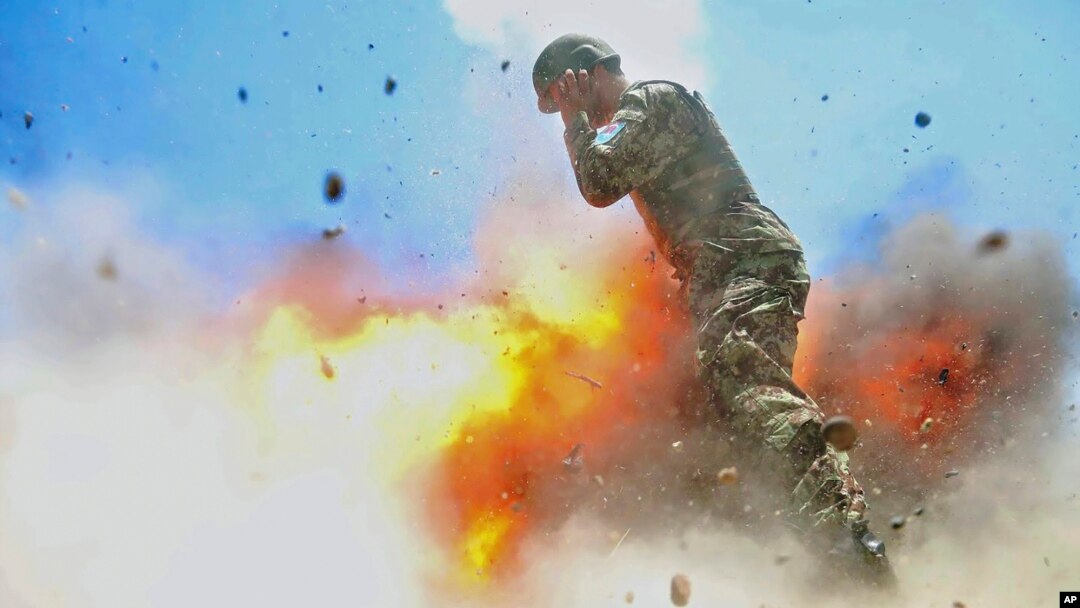 U.S Army combat camera photographer Spc. Hilda Clayton took this photo July 2, 2013 that was released by the U.S. Army, that shows an Afghan soldier engulfed in flame as a mortar tube explodes during an Afghan National Army live-fire training exercise.