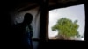 FILE - A South Sudanese refugee stands by a window, in Bidi Bidi, Uganda, June 3, 2017. A new report says South Sundanese activists abroad, including in Uganda, are being targeted by the government in Juba.