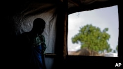 FILE - A South Sudanese refugee stands by a window, in Bidi Bidi, Uganda, June 3, 2017. A new report says South Sundanese activists abroad, including in Uganda, are being targeted by the government in Juba.