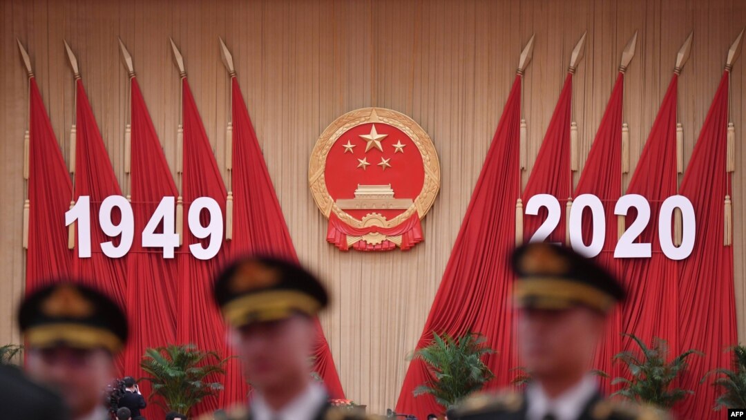 Members of a Chinese military band pose for photos before a reception at the Great Hall of the People in Beijing on the eve of China's National Day on Sept. 30, 2020.