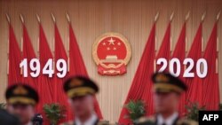 Members of a Chinese military band pose for photos before a reception at the Great Hall of the People in Beijing on the eve of China's National Day on Sept. 30, 2020.