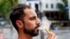 FILE - FILE - Vaping by a man in a street in Auckland, New Zealand, Thursday, Dec. 9, 2021. 