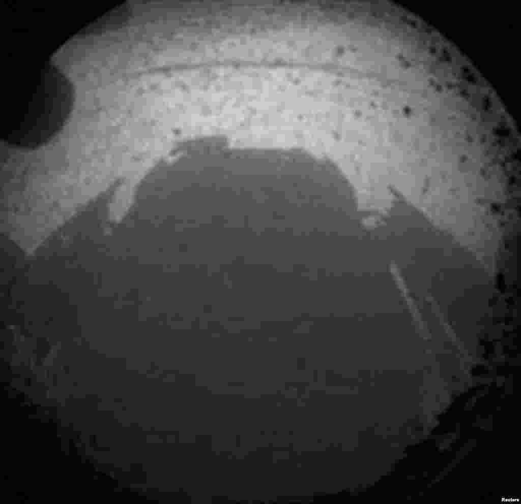 One of the first views from NASA's Curiosity rover, which landed on Mars on August 5, 2012. It was taken through a wide-angle lens on one of the rover's Hazard-Avoidance cameras.