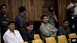 From left to right, Daniel Martinez, Carlos Antonio Carias, Manuel Pop Sun, and Reyes Collin Gualip, sit in the courtroom during the first day of their trial in Guatemala City, July 25, 2011