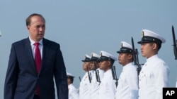FILE - Australian Minister of Immigration and Border Protection Peter Dutton inspects guards of honor during a ceremony for the arrival of the first Malaysia Maritime Enforcement Agency bay class vessel in Port Klang, outside Kuala Lumpur, Malaysia, Feb. 27, 2015. 